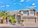 Two story home with a well manicured front yard and a two car garage at 7520 Jacaranda Bay St, Las Vegas, NV 89139