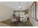 Cozy dining area with hardwood floors, stylish furnishings, and natural light from shuttered windows at 7705 Lily Trotter St, North Las Vegas, NV 89084