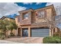 Inviting two-story home with brick driveway, attached two-car garage and landscaped front yard at 92 Tesla Ridge Way, Las Vegas, NV 89183