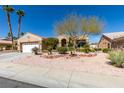 Inviting single-story home with a manicured front yard, desert landscaping, and an attached two-car garage at 9816 Gerald Ct, Las Vegas, NV 89134