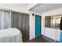 The image shows an outdoor balcony with a blue front door, sliding glass doors, and clothes rack at 1455 E Katie Ave # A21, Las Vegas, NV 89119