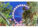 A view of the High Roller Wheel from ground level with palm trees at 210 E Flamingo Rd # 326, Las Vegas, NV 89169