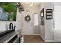 Inviting entryway featuring wood-look floors, decorative wreath, and stylish decor at 2199 Maple Shade St, Henderson, NV 89002