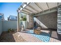 Inviting outdoor patio with brick flooring, pergola, and a cozy fire pit at 2514 Spergola St, Henderson, NV 89044