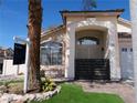 Charming home exterior with a 'For Sale' sign, lush landscaping, and a welcoming gated front entrance at 297 Gingerbread St, Henderson, NV 89012
