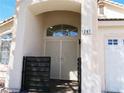 Close-up of the front entrance with decorative gate, arched doorway, and clear numbering of the house at 297 Gingerbread St, Henderson, NV 89012