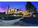 Mountain home at dusk with beautiful balconies, large windows, and inviting lighting at 306 Crestview Dr, Las Vegas, NV 89124