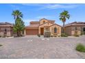 A charming single-Gathering house on a paved driveway lined with desert foliage under a bright blue sky at 33 Via Di Mello, Henderson, NV 89011