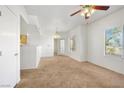 Inviting living room with neutral carpet, ceiling fan, and natural light from a large window at 3400 Cabana Dr # 2103, Las Vegas, NV 89122