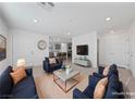 Staged living room with neutral walls, plush seating, and ample natural light at 3541 Arcadian Sea St, Las Vegas, NV 89106