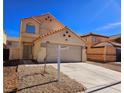 Two-story home featuring a two-car garage, rock landscaping, and neutral color palette in a well-maintained neighborhood at 4064 Browndeer Cir, Las Vegas, NV 89129