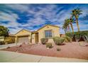 Attractive single-story house featuring desert landscaping, palm trees, and a convenient two-car garage at 4204 Sunset Falls Ave, North Las Vegas, NV 89085