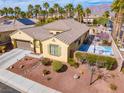 Desirable single-story residence showcasing desert landscaping, a basketball court, and a two-car garage at 4204 Sunset Falls Ave, North Las Vegas, NV 89085