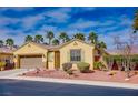 Charming single-story home with desert landscaping, complemented by palm trees and a two-car garage at 4204 Sunset Falls Ave, North Las Vegas, NV 89085