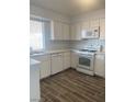 Bright kitchen featuring white cabinets, stainless steel appliances, tile flooring, and a sunlit window at 4300 Don Quixote St, Las Vegas, NV 89121