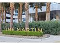 Landscaped entrance to The Martin featuring neatly trimmed hedges and palm trees at 4471 Dean Martin Dr # 2605, Las Vegas, NV 89103