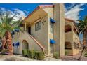 Attractive condo exterior with stairs leading to the second level and blue awnings at 4706 Obannon Dr # C, Las Vegas, NV 89102