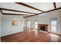 Bright living room with wood floors, fireplace, and beamed ceilings at 4706 Obannon Dr # C, Las Vegas, NV 89102