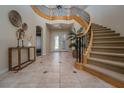 Grand foyer with a winding staircase, tile flooring, and elegant decor creating a welcoming entrance at 504 Pinnacle Heights Ln, Las Vegas, NV 89144