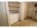 Laundry area with washer, dryer and shelving for storage at 5612 W Lake Mead Blvd, Las Vegas, NV 89108