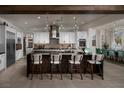 Bright, spacious kitchen featuring modern white cabinets, stainless steel appliances, a large island, and pendant lighting at 5725 N Conquistador St, Las Vegas, NV 89149