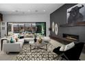 Contemporary living room with fireplace, stylish décor, and sliding glass doors to an outdoor seating area with mountain views at 5725 N Conquistador St, Las Vegas, NV 89149