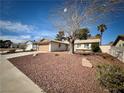 Charming single-story home featuring desert landscaping and a large tree at 6412 Churchfield Blvd, Las Vegas, NV 89103