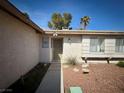 Inviting front entrance with a security screen door and desert landscaping at 6412 Churchfield Blvd, Las Vegas, NV 89103