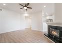 Bright living room with a fireplace, wood-look floors, and an open layout to a dining area at 9000 Las Vegas Blvd # 1043, Las Vegas, NV 89123