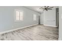 Bright bedroom with modern gray flooring, white trim, fresh paint and plantation shutters for a modern, clean look at 9314 Indian Corn Ct # 102, Las Vegas, NV 89178