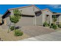 Attractive single-story home with a brick driveway, complemented by tasteful landscaping, and neutral exterior color at 9940 Heather Moore Ave, Las Vegas, NV 89166