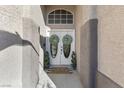 Inviting entryway with double doors, decorative wreaths, and well-maintained landscaping creates a warm welcome at 10638 La Spezia Way, Las Vegas, NV 89141