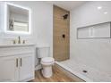 Modern bathroom featuring a walk-in shower with white tile and a sleek vanity with gold fixtures at 1209 S 17Th St, Las Vegas, NV 89104