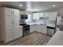 Bright kitchen features white cabinets, stainless steel appliances, and a modern countertop at 1642 Palma Vista Ave, Las Vegas, NV 89169