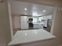 Open kitchen view with stainless steel appliances and white cabinets, showcasing its modern design at 1642 Palma Vista Ave, Las Vegas, NV 89169