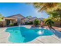 Backyard view of a well-maintained pool with a surrounding patio area and manicured landscaping at 2160 Point Mallard Dr, Henderson, NV 89012