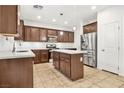 A well-equipped kitchen features stainless steel appliances, granite countertops, and an island for extra workspace at 2205 Stone Well Rd, North Las Vegas, NV 89031