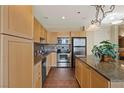 Bright kitchen featuring granite countertops, stainless steel appliances, tile backsplash, and stylish light fixture at 2405 W Serene Ave # 631, Las Vegas, NV 89123