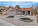 Charming single-story home with terracotta roof, desert landscaping, and two-car garage at 3104 Waterview Dr, Las Vegas, NV 89117