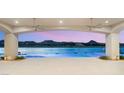 Covered patio shows views of the lake, desert mountains, and neighborhood through an archway at 32 Grand Corniche Dr, Henderson, NV 89011