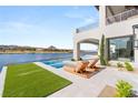 Modern outdoor pool and patio area with beautiful views of the lake and surrounding hills at 32 Grand Corniche Dr, Henderson, NV 89011