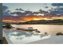 Beautiful infinity pool overlooking the lake with mountain views at sunset at 32 Grand Corniche Dr, Henderson, NV 89011