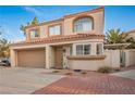 Attractive stucco townhome with a terracotta tile roof, spacious two-car garage, and lovely curb appeal at 3331 Cheltenham St, Las Vegas, NV 89129