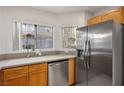 Bright kitchen offers stainless steel refrigerator, white countertops, and stainless dishwasher at 3331 Cheltenham St, Las Vegas, NV 89129