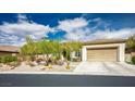 Single-story home featuring low-maintenance landscaping, desert plants, and a two-car garage at 34 Contra Costa Pl, Henderson, NV 89052