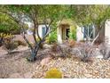 Landscaped front yard featuring drought-tolerant plants and rock accents near the house at 34 Contra Costa Pl, Henderson, NV 89052
