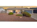 Charming single-story home with desert landscaping, a blue front door, and a two-car garage at 3492 Edison Ave, Las Vegas, NV 89121