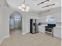 Bright kitchen with white cabinetry, stainless steel appliances, and tiled flooring at 4585 Coral Silk Ct, Las Vegas, NV 89110