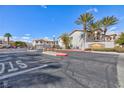 Gated community entrance featuring desert landscaping, palm trees, and a clear blue sky at 4820 Grey Wolf Ln # 101, Las Vegas, NV 89149