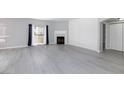 Spacious living area with wood-look flooring, fireplace, and lots of natural light at 4820 Grey Wolf Ln # 101, Las Vegas, NV 89149